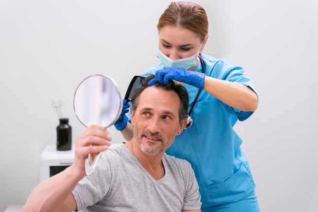 Free photo adult male getting a hair loss treatment