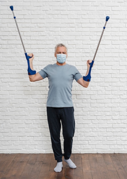 Free photo adult male posing with his crutches