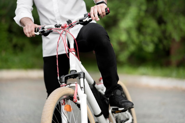 Free photo adult male riding modern bicycle outdoors