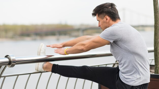 Adult male warming up before jogging