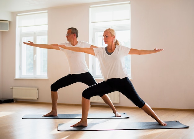 Free Photo adult male and woman exercising together