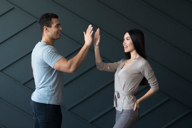 Free photo adult male and young woman ready to high five