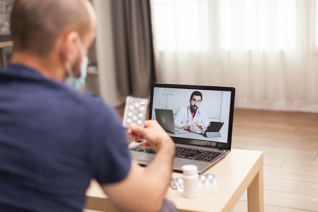 Free photo adult man talking with doctor about his treatment during global pandemic.