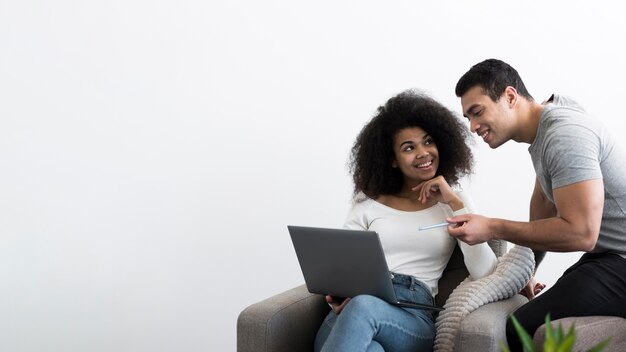 Adult man and woman working on a laptop together