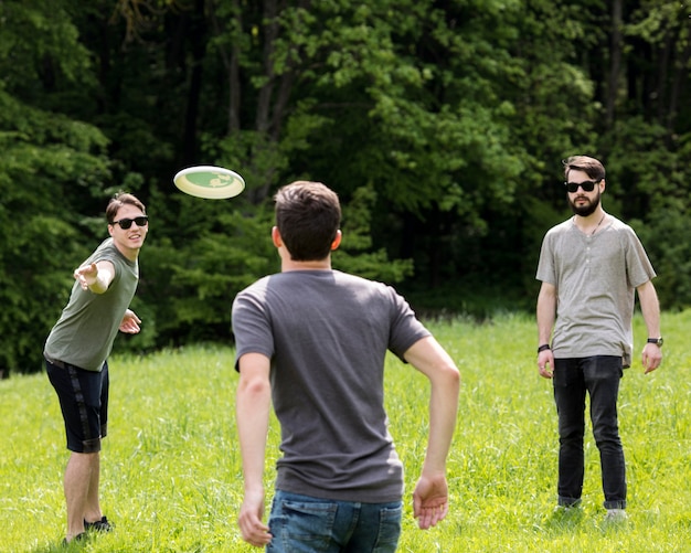 Free photo adult men having fun while playing frisbee