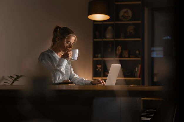 Adult person working on home computer at night