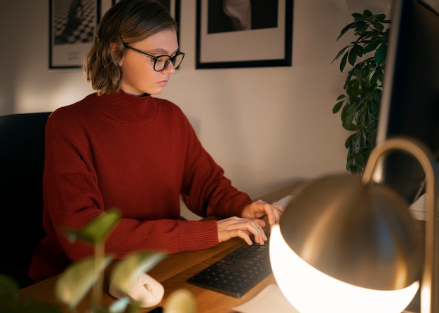 Free photo adult person working at home late at night