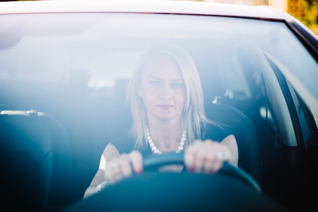 Free photo adult serious woman in car