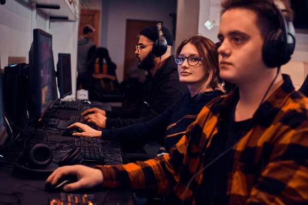 Adult tired boys and girl are playing videogames at popular cyber championship.