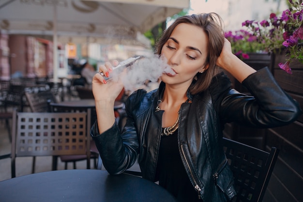 Adult touching her head while smoking