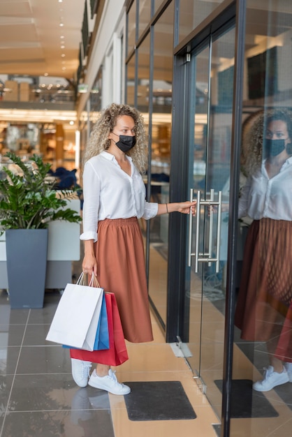 Free Photo adult woman carrying shopping bags