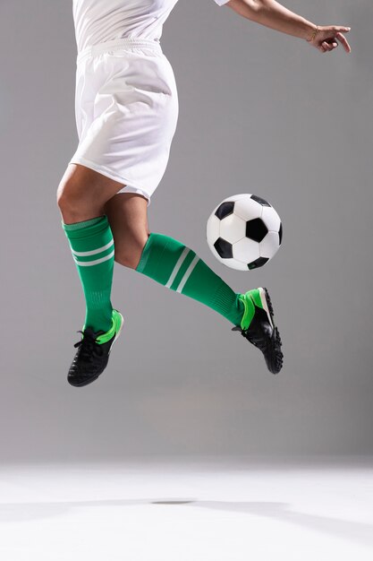 Adult woman doing tricks with soccer ball