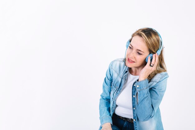 Adult woman enjoying music in headphones