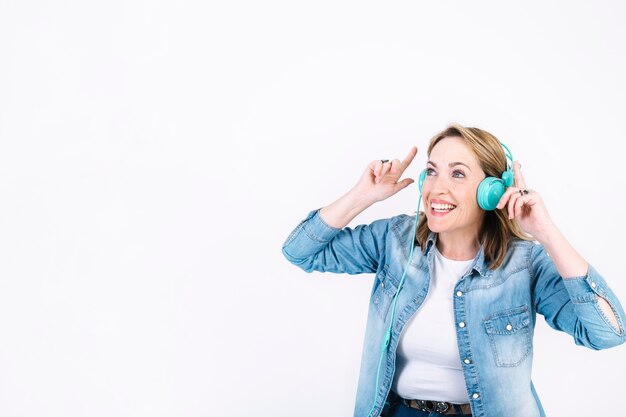 Free Photo adult woman in headphones pointing up