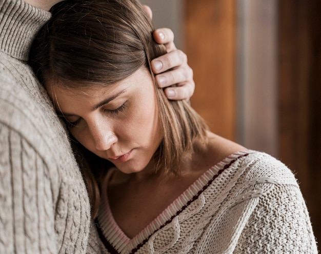 Adult woman hugging her husband