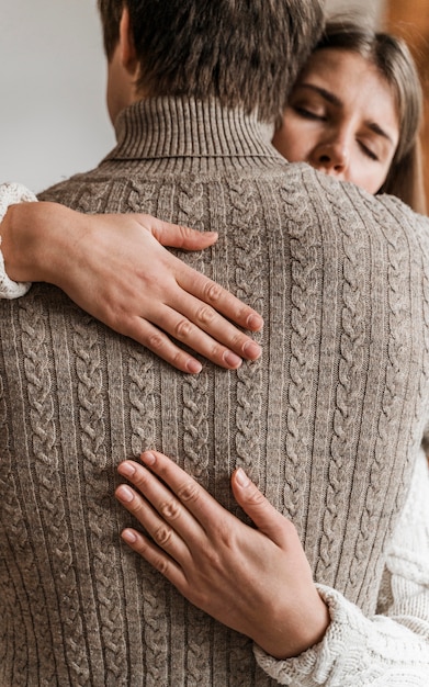 Adult woman hugging her husband