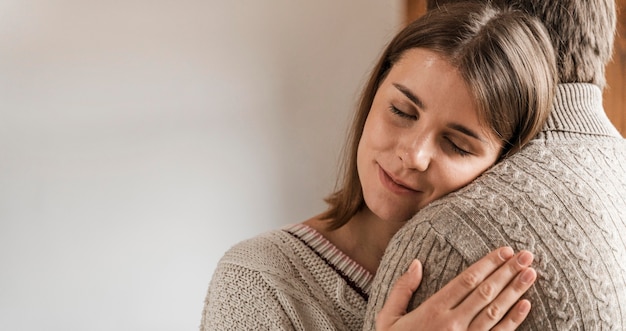 Free photo adult woman hugging her husband