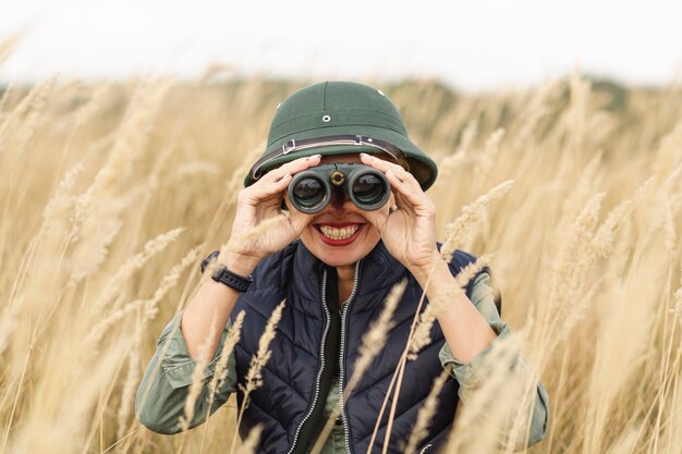 Adult woman looking into binoculars