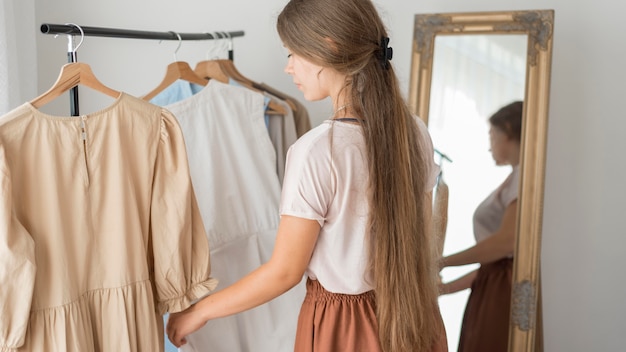 Free photo adult woman trying out new clothes