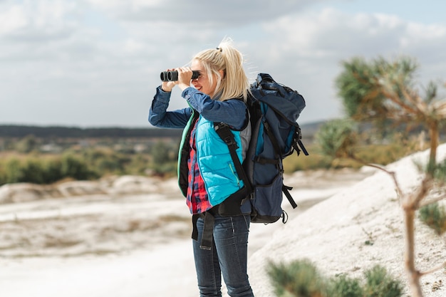 Free photo adult woman with binoculars outdoor