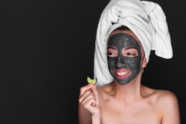 Adult woman with mud mask on her face