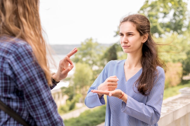 Adult women communicating through sign language