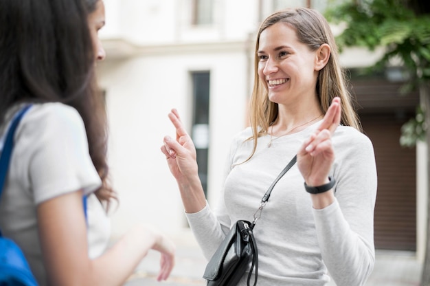 Free photo adult women communicating through sign language