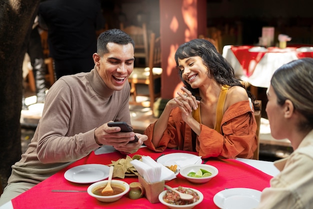 Adults enjoying mexican food