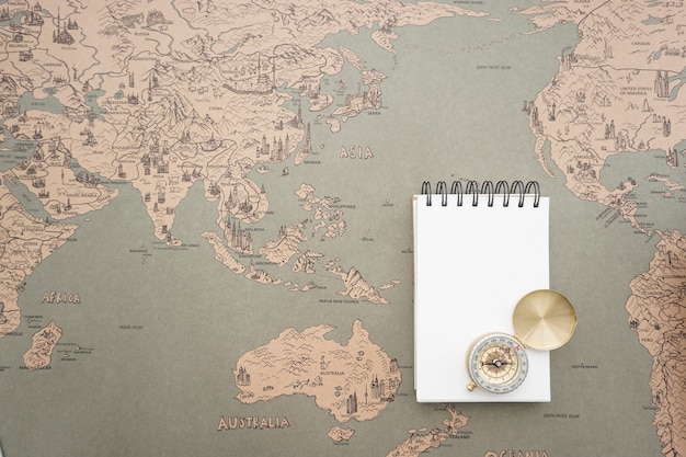 Free Photo adventure background with blank notebook and compass