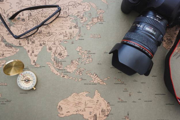 Free photo adventure background with compass, camera and glasses