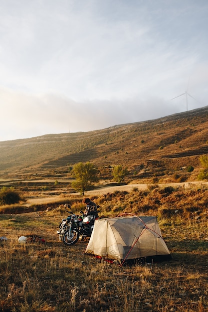 Free Photo adventure motorcyclist camping in wild