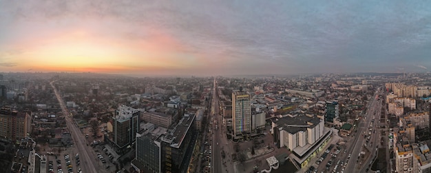 Free photo aerial drone panorama view of chisinau at sunset. multiple office and residential buildings, roads with multiple cars.