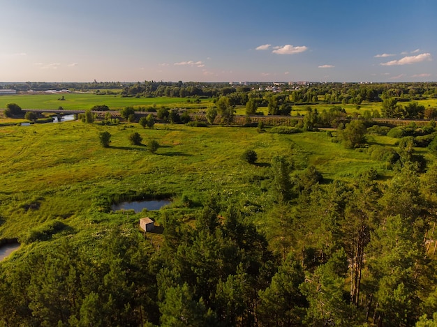 Aerial drone view The bend of a wide river among green meadows