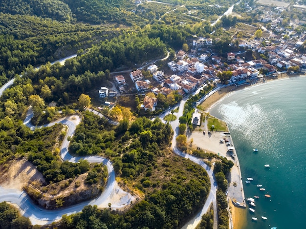 Aerial drone view of blue sea and windy mountain roads in Halkidiki Greece