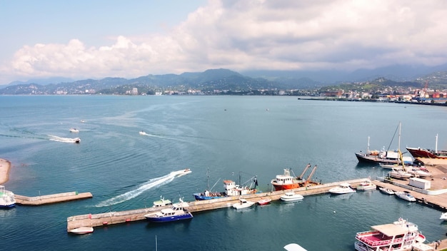 Free photo aerial drone view of the coastline in batumi georgia black sea sea port boats mountains