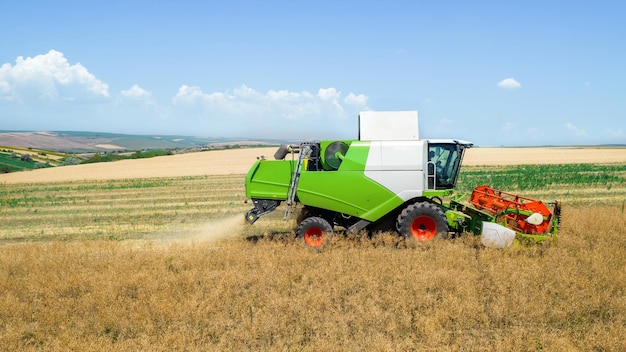 Free photo aerial drone view of the harvester gathering crops