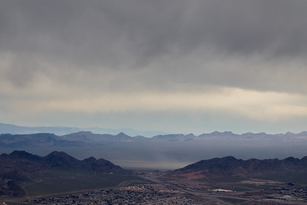 Free photo aerial of mountains under cloudy sky