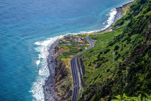 Aerial photography shot of a highway in the mountains on the shore of Madeira