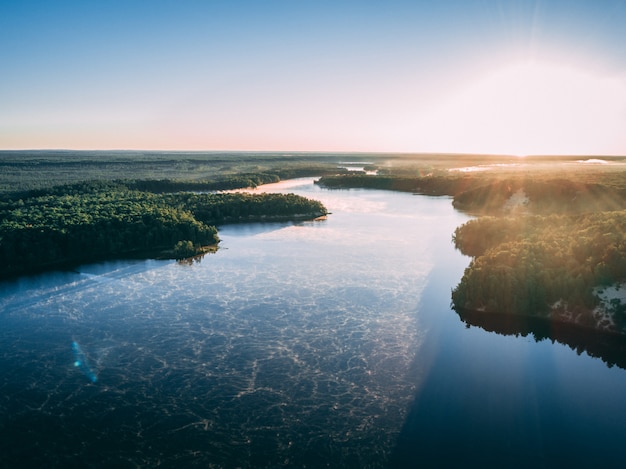 Free photo aerial picture of a river surrounded by islands covered in greenery under sunlight