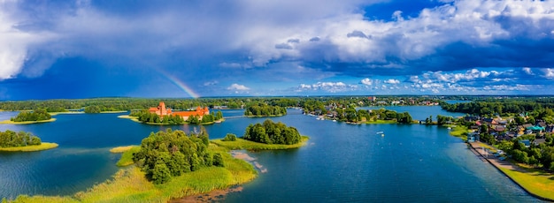 Free photo aerial shot of an amazing lake surrounded by green forests and an island with an old castle