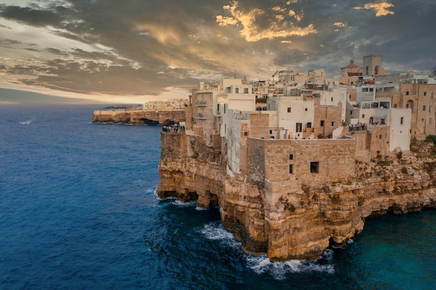 Aerial shot of ancient city with old houses on the top of the rocky cliff