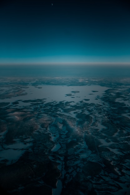 Free Photo aerial shot of a beautiful landscape covered with snow in the early morning