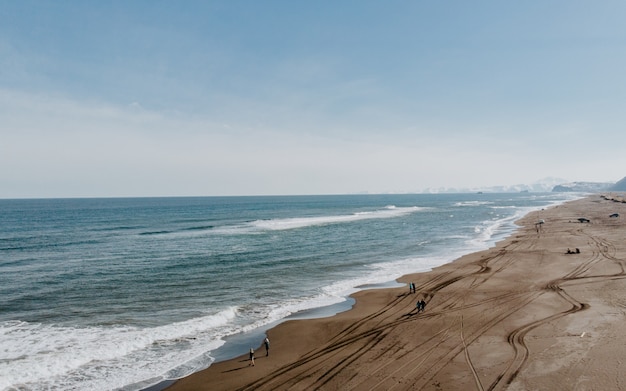 Aerial shot of the beautiful shoreline and the sandy beach and amazing sky