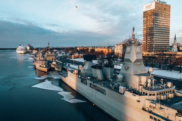 Aerial shot of big military ships in a harbor during winter