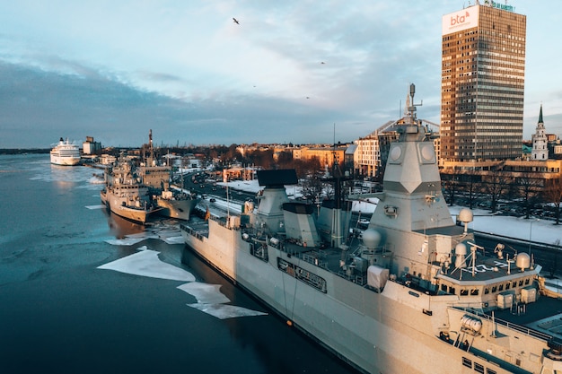 Aerial shot of big military ships in a harbor during winter