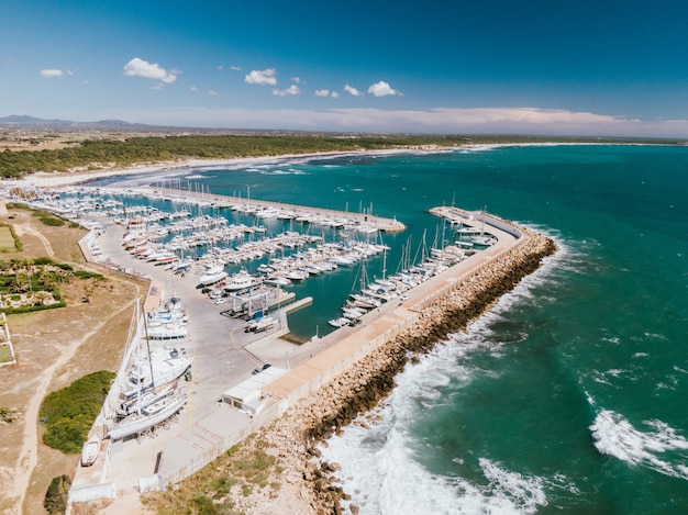 Aerial shot of a dock with many boats docked in the water