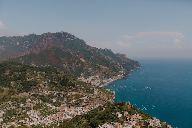 Free Photo aerial shot of a landscape with buildings on the coast of the sea in italy