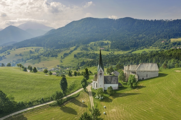 Free Photo aerial shot of the lese church in slovenia in a valley