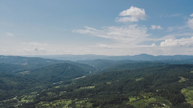 Aerial shot of low hills covered in green