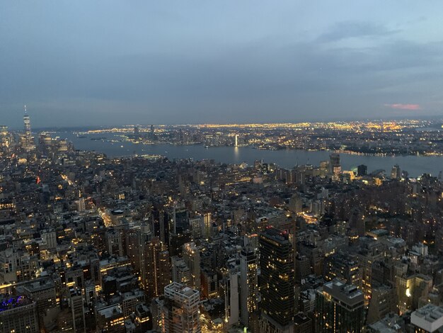 Aerial shot of a megapolis with illuminated high buildings